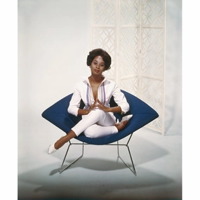 "Young Woman Sitting on Armchair" from Getty Imagesnordic style wall decor